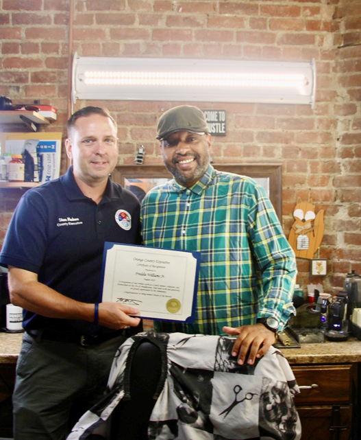 Orange County Executive Steven M. Neuhaus with Freddie Williams at 6 West Barbershop in Middletown.