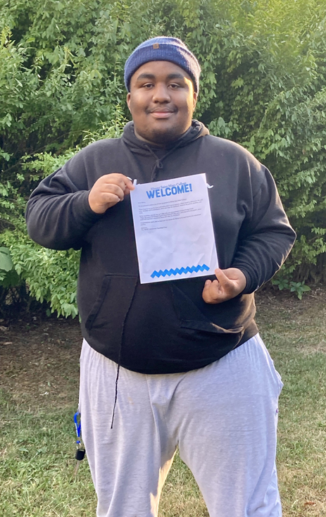 Henry Spencer, proudly shows off his latest accomplishment - an acceptance letter into Mount Saint Mary College’s Bachelor of Science in Cybersecurity program.