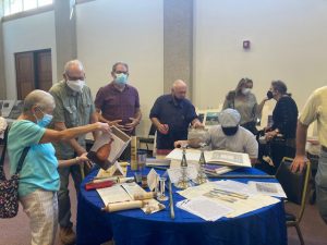 Guests at Sunday’s first- ever Jewish Museum I’m the Hudson Valley, a pop-up event, carefully look over some authentic artifacts from local and European History at Temple Beth Jacob in Newburgh.