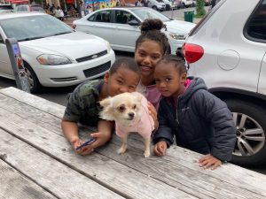 Zairean, JuJu and Zaydah Harris, along with their dog Bella, from the Town of Newburgh wait for the start of Sunday’s Spirit of Beacon Parade.