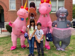 The Unicorn Group Floats, who participated in the Beacon Spirit Day, take a break to pose with two admirers, Vanessa and Mateo Aguilar.
