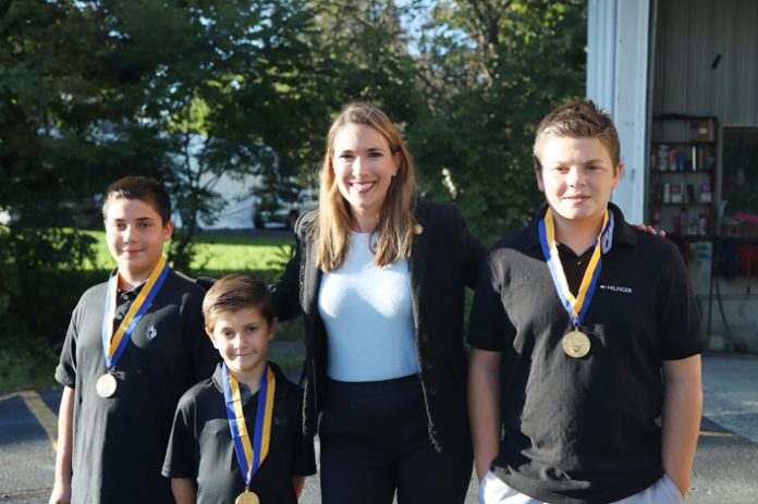 Senator Michelle (center) Hinchey awarded Peter Liquari IV and Nickolas Liquari, both 14, and their brother Dylan Liquari, 7, of Greenville with Liberty Medals for their heroic actions in saving the life of a man trapped in a burning car following a crash in Greenville.