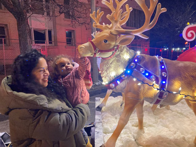 City of Newburgh resident, Yani Jimenez and her daughter Naomi admire the reindeer on the handmade sleigh at last Tuesday’s City of Newburgh Annual Holiday Tree Lighting.