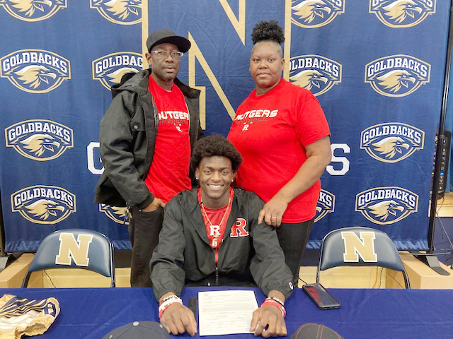 Newburgh Free Academy West Senior, Deondre Johnson, seen here with his parents, signed a Letter of Intent to play football for Rutgers University Thursday afternoon in front of a large, supportive crowd of family and friends.