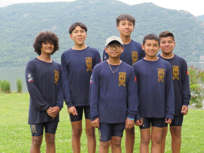Oscar (front left) and Gustavo (front, right) with San Miguel Academy’s National Championship team at their boat launch in Donohue Park in Cornwall, NY.