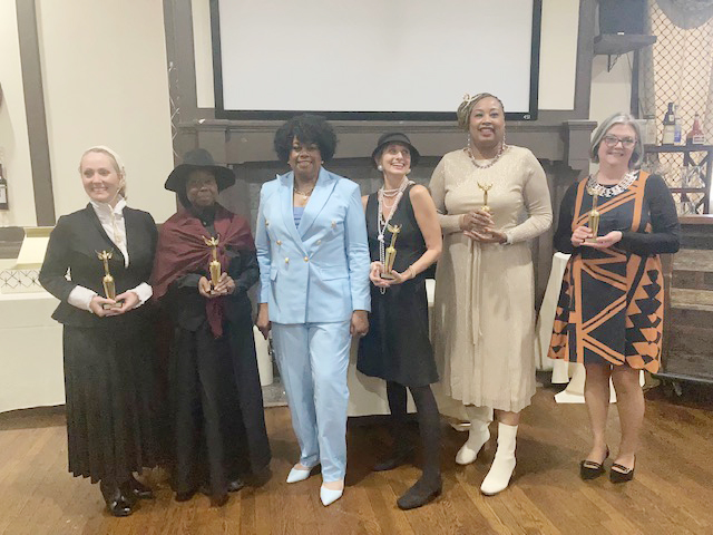 Shirley Sutphin, CEO of Let’s Talk, center, which hosted Saturday’s “I’m Every Woman” event, is surrounded by the talented women who contributed to the luncheon’s acting and music entertainment.
