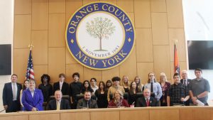 Group picture of students with members of the Orange County Legislature.