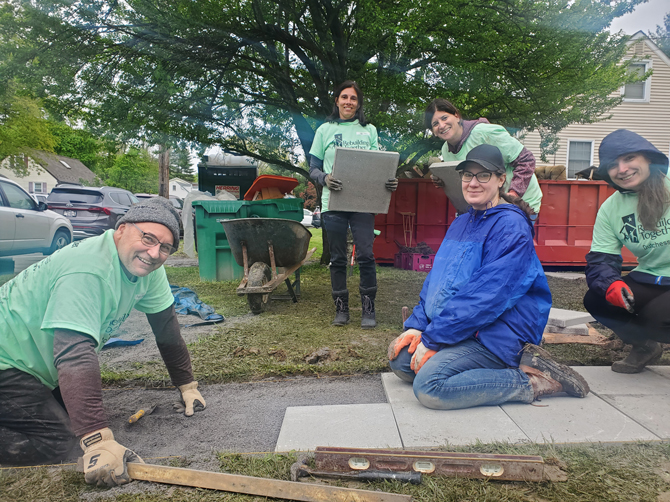 Volunteers from Arlington Teachers’ Association and Poughquag United Methodist Church replace Ann’s front walkway.