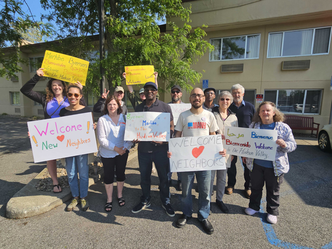 On Sunday, members of grassroots organization For the Many, Mid-Hudson Valley DSA, and Councilmember Megan Deichler greeted and applauded asylum seekers arriving at Poughkeepsie’s Red Roof Inn.