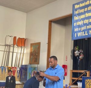 New York Giants wide receiver, Collin Johnson, presents a medal to one of the members of the Class of 2023 San Miguel Academy Thursday night at the school’s Commencement Exercises.