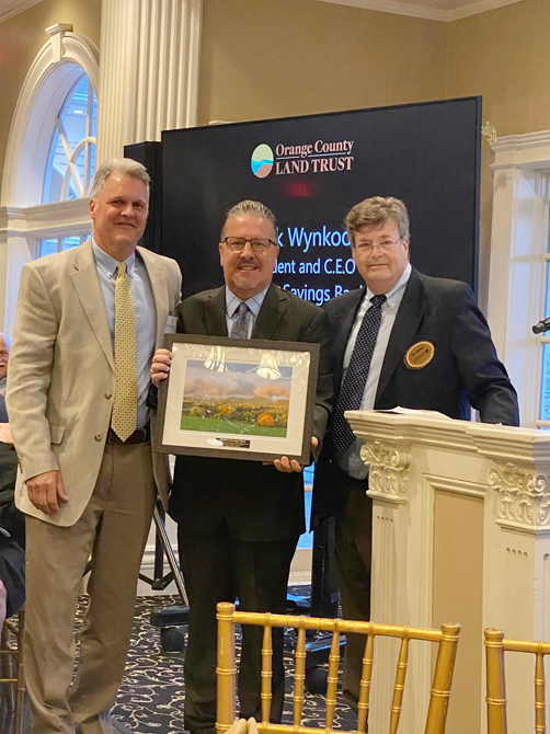 From left, Walden Savings Bank Senior Vice President Brian Ratynski; Walden Savings Bank President and CEO Derrik Wynkoop; and Jim Delaune, Executive Director of the Land Trust pose for a photo.