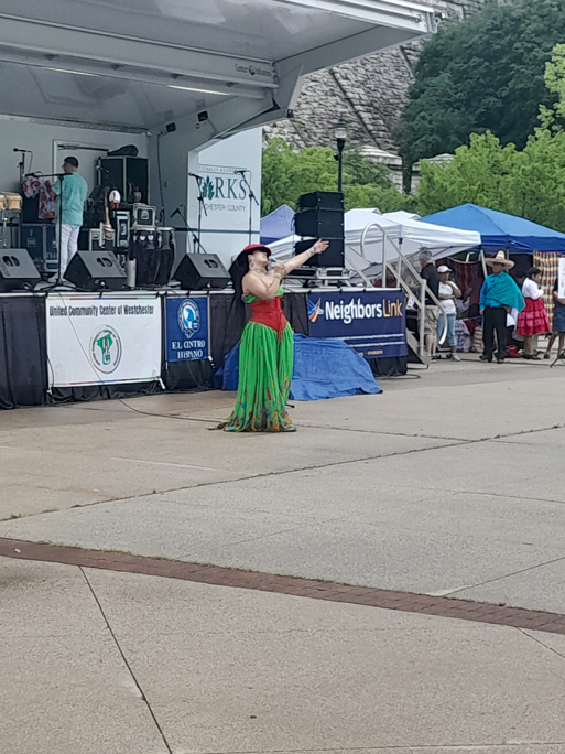Performer singing in front of crowd at the annual Hispanic Heritage festival at the Kenisco Dam Plaza.