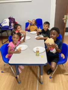 Children at Newburgh’s Boys and Girls Club enjoy a pizza lunch Thursday afternoon at the Liberty Street location. Also part of the busy day was a talent show as well as special visit by Hamilton Burger, son of Harvey Burger, who spoke about the deep history of the building and its programs.