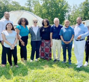 Pictured with Speaker Carl Heastie at the Newburgh Urban Farm and Food in Newburgh are (from left to right): Newburgh Manager Todd Venning, Newburgh Councilmember Giselle Martínez, Orange County Legislator Genesis Ramos, Newburgh Urban Food and Farm Executive Director Virginia Kasinki, City of Poughkeepsie Councilmember Yvonne Flowers, Assemblymember Jonathan G. Jacobson and Newburgh Mayor Torrance Harvey.