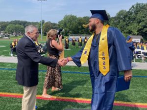 Mr. William Kaplan, member of the Newburgh Free Academy class of 1945 who was honored as the first inductee to the Newburgh Free Academy Hall of Fame, congratulates graduates at the August Commencement for the Class of 2023 on Monday, August 21, 2023.