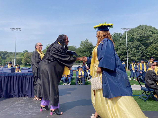 On left, Dr. Jacklielyn Manning Campbell, Superintendent of the Newburgh Enlarged City School District, congratulates graduates on Academy Field during the August Commencement for the Class of 2023 on Monday, August 21, 2023.