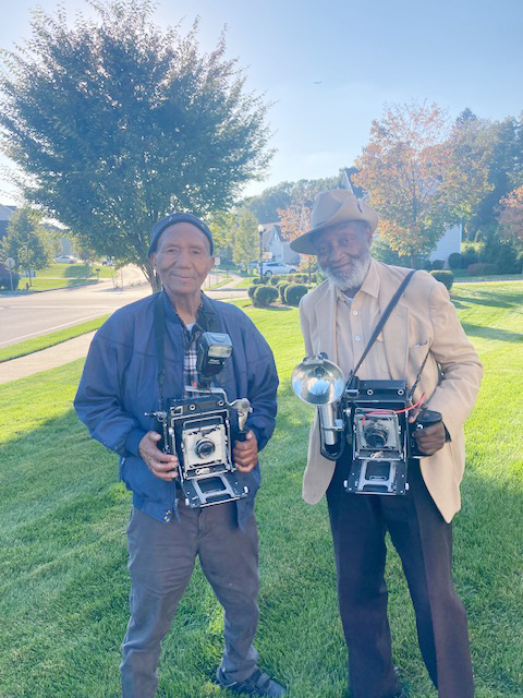 Legendary street photographers; on left, Bob Taylor, and on right, Louis Mendes, recently connected in Dutchess County to share memories.