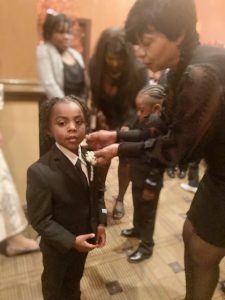 Sheree Anderson shows off the beautiful corsages she pinned on some of the boy participants at Saturday’s Inaugural Emerging Leaders Elementary Cotillion.