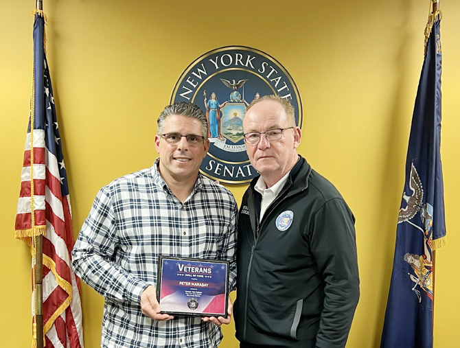 Sen. Rob Rolison (39th District) presents Air Force veteran Peter Maraday with an official Hall of Fame plaque.