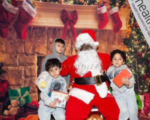 Children pose for a picture with Santa Claus after receiving a gift from Toys For Tots at Healthfirst on Saturday, December 9, 2023. Hudson Valley Press/CHUCK STEWART, JR.