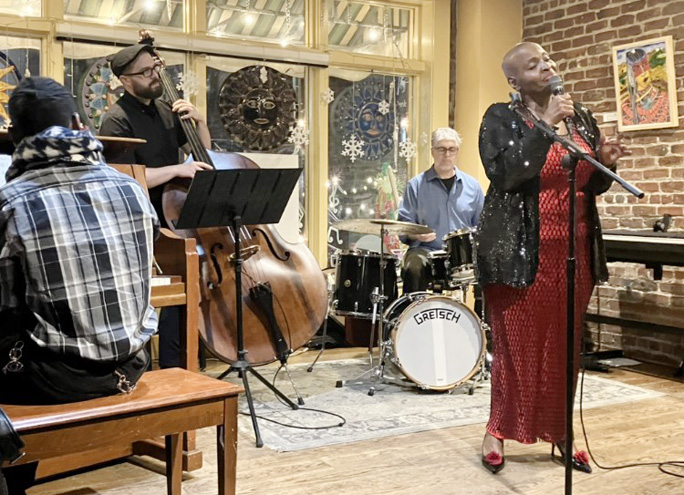 Piano player Darius Beckford, bass player Ben Basile, and drummer Eric Puente accompany Lady Kat Sings at The Bean Runner Cafe.