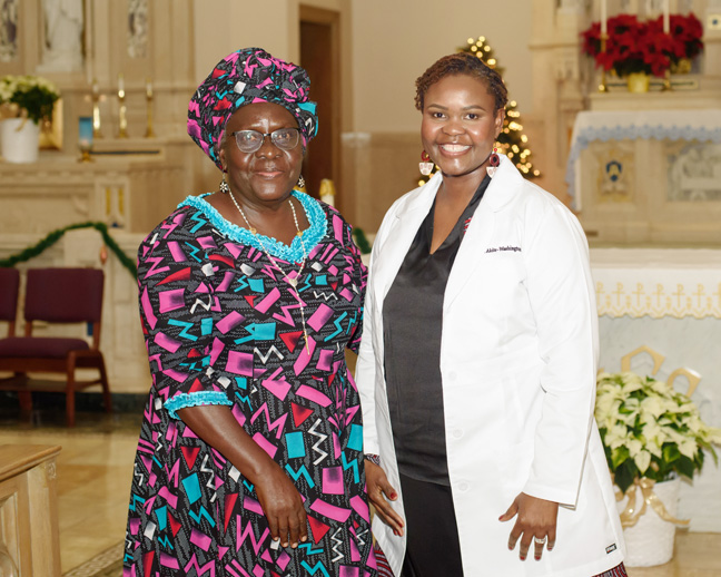 Lydia Akite of Middletown, N.Y. (right) presented a reflection to the new Mount Saint Mary College graduates. Her mother (left) traveled from Uganda to present her daughter with the white coat. Photo: Dean DiMarzo