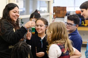 Mount Saint Mary College student Ashley Leonor of New Windsor, N.Y. wows Bishop Dunn Memorial School students with a density experiment on March 19. Photo: Lee Ferris