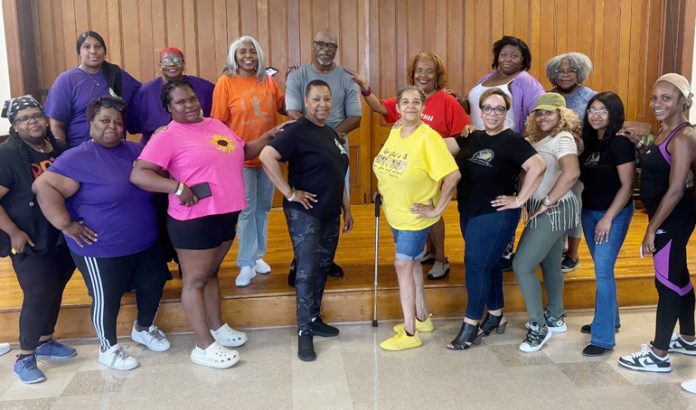 Participants pose for a photo with Instructor Steve “Fun Bunch” Dillard after Gospel Line Dancing Workshop at Baptist Temple.