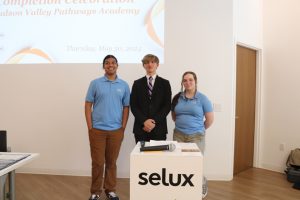 Hudson Valley Pathways Academy Young Scholars Jacob Ramatour, Tucker Chase, and Natalie Winrow pose for a photo prior to the start of the Completion Ceremony which they planned and executed on May 30 at Selux Corporation in Highland, NY. 
