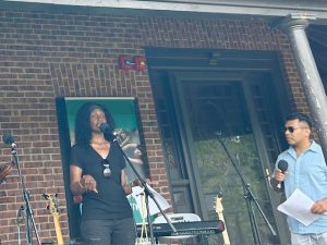 Jeannine Otis, Music Director for Rural Migrant Ministries and co- host of Saturday’s Voices for Hope concert, addresses the crowd just prior to the start of the wide ensemble of music acts to take the stage.