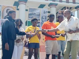 Mr. Kevin Douglass Greene, great- great grandson of historic trailblazer Frederick Douglass hands out books to high schoolers who attended the Celebrating the African Spirit Program, on his relative’s legacy.