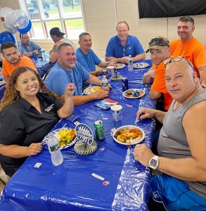 Superintendent of Public Works George Garrison (head of table) poses with Bilingual Clerk Maritza Wilson and former and current coworkers at his surprise retirement party.