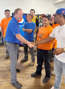 Superintendent of Public Works George Garrison shakes hands with his co-workers at his surprise retirement party.