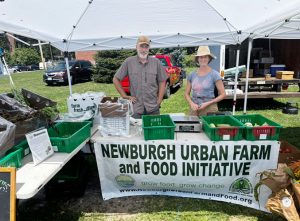 Farm Manager Jeffrey McConnaughey and Assistant Farmer Jennifer Goldfrank of Downing Park Urban Farm pose for a photo at the Healthy Orange Farmers Market.