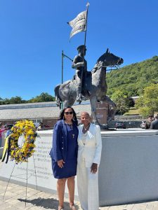 On left is Dr. Aundrea Matthews, President of the Highland Falls Buffalo Soldiers Chapter and granddaughter of the man, Staff Sergeant Sanders H. Matthews, whose likeness is depicted on the statue behind her, with Edweana Aiken, Iota Alpha Omega Chapter of Alpha Kappa Alpha Sorority, Inc. as well as a director descendant of a Buffalo Soldier.