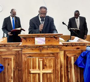 Pastor Errol O'Connell (center) gave a powerful message at Mount Triumphant Church of God's Dedication Service.
