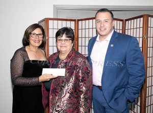 Norma Ramirez and Eddie Ramirez receive a donation from JoAnn Lugo, center, as Latinos Unidos of the Hudson Valley hosted its 19th annual Hispanic Heritage Cultural Celebration on Saturday, October 25 at The Powelton Club. Hudson Valley Press/CHUCK STEWART, JR.