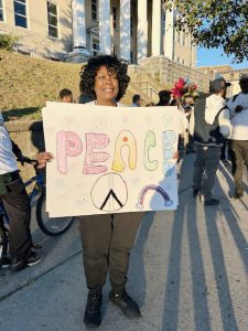 Gabrielle Hill, organizer of Thursday’s 30th Year Commemoration of the Million Man March, gets into the Spirit Thursday night prior to the event’s start.