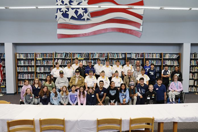 Saugerties Junior High School students pose for a group photo with local veterans prior to the Veterans Day Assembly.