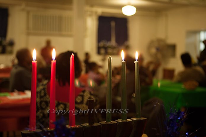 Candles are lite during the Kwanzaa holiday which is celebrated by millions worldwide to strengthen the values of African heritage and reinforce community among African Americans. Hudson Valley Press File/CHUCK STEWART, JR.