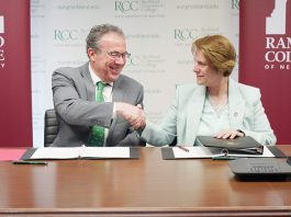 Dr. William P. Mullaney, president of Rockland Community College, and Dr. Cindy Jebb, president of Ramapo College, shake hands following the signing of a transfer agreement creating a direct pathway for RCC students to earn a bachelor’s degree with junior standing at Ramapo College.