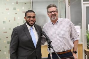 Dr. Demario Strickland presented trustee Dr. Chris McDonough with a certificate noting his achievement.
