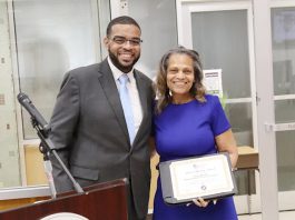 Dr. Demario Strickland presented Board of Education President Dr. Donna Marable with a certificate noting her achievement.