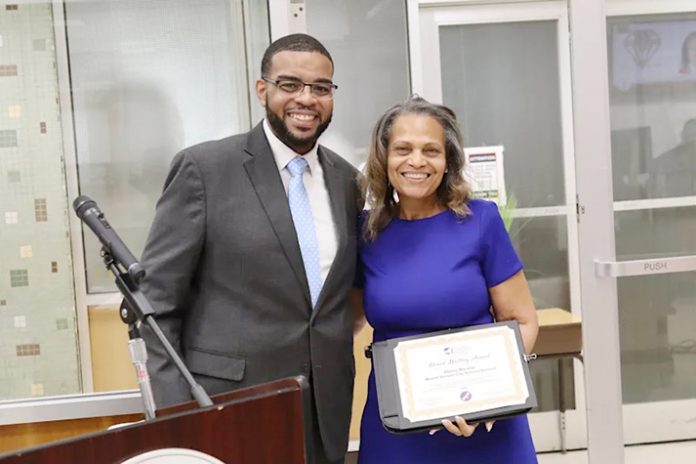 Dr. Demario Strickland presented Board of Education President Dr. Donna Marable with a certificate noting her achievement.