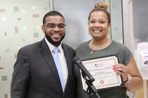 Dr. Demario Strickland presented trustee Erica Peterson with a certificate noting her achievement.