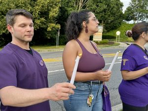 At a vigil, caregivers share stories of broken bones, blackened eyes, lost time due to workplace violence; worker burnout; and chronic understaffing while calling on WMCHealth to raise standards for workers and patients.
