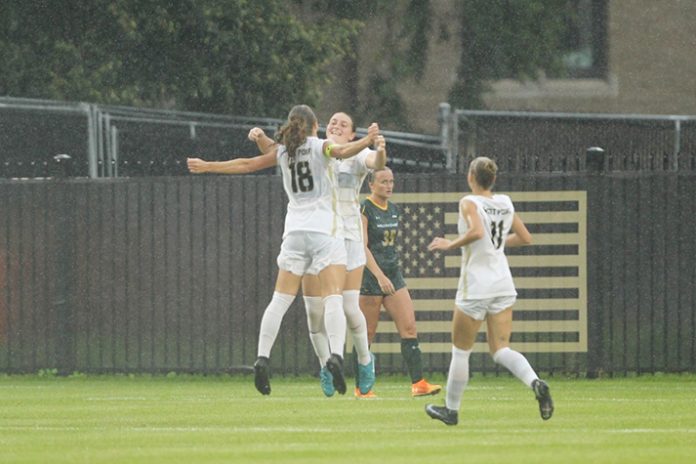 Kamryn McWhinney and Bella Conti Celebrate McWhinney's First Career Goal in 3-2 Win Over William & Mary. Photo: Mady Salvani