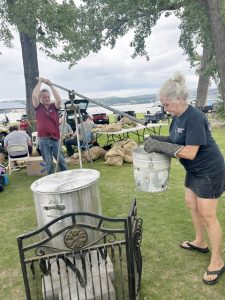 Sloop Club volunteers prepare to release the just boiled corn on the cob from a huge pot Sunday.