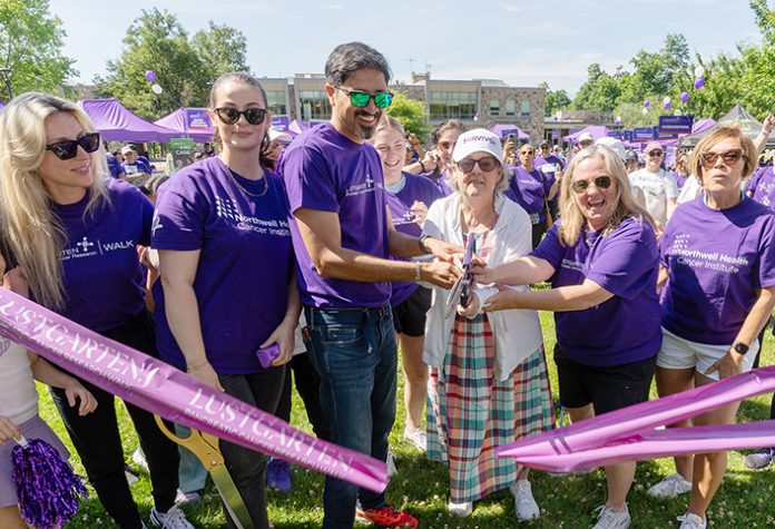 Dobbs Ferry resident and pancreatic cancer survivor Sharon Bond, wearing a "Survivor" cap, cuts the ribbon alongside her oncologist, Keyur Thakar, MD, at the 17th annual Lustgarten Foundation Westchester Walk for Pancreatic Cancer Research at Westchester Community College in Valhalla. Photo credit: Lustgarten Foundation