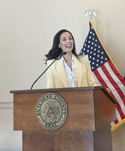 Micah Smith, President & Founder Micah Abigail, LLC, addresses guests about her completely serendipitous path in the credit recovery, incited by her fortitude in facing her personal challenges.